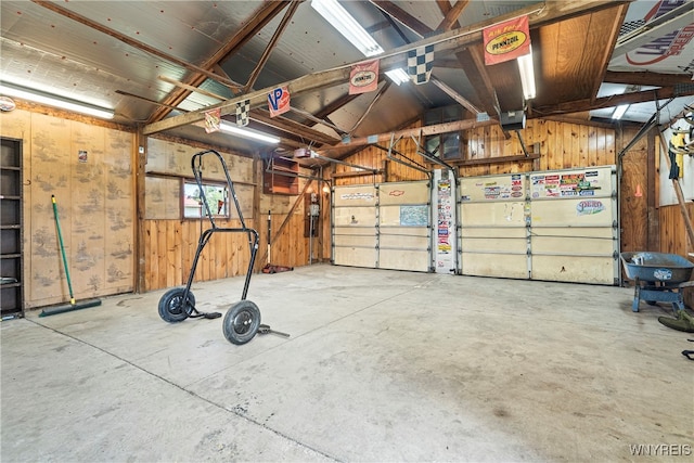 garage featuring wood walls