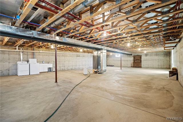 basement featuring washer and dryer and heating unit