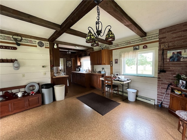 kitchen with beam ceiling, decorative light fixtures, a baseboard radiator, and plenty of natural light