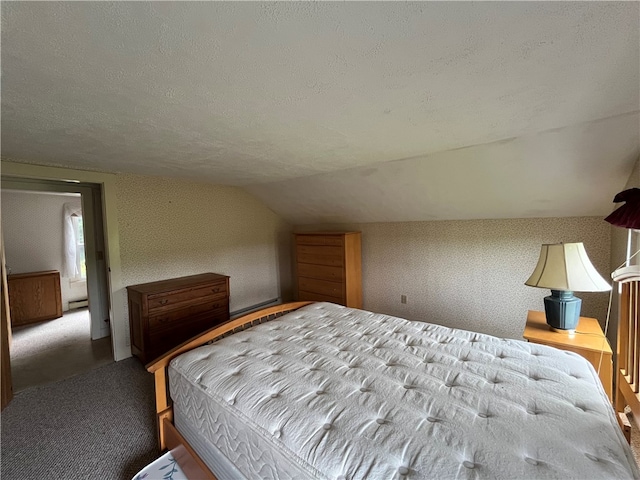 unfurnished bedroom featuring carpet flooring, vaulted ceiling, and a textured ceiling