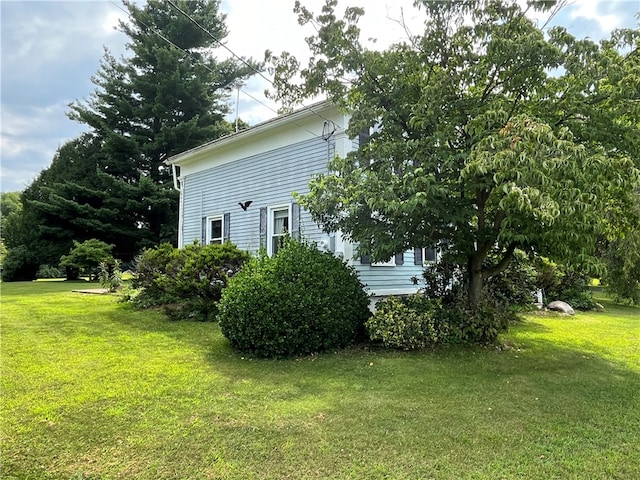 view of side of property featuring a yard