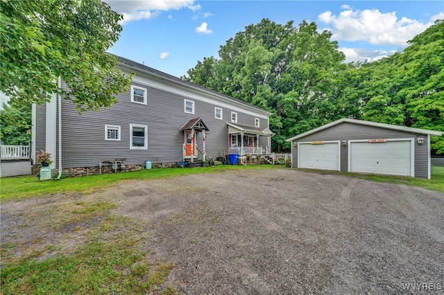 view of front of house with an outbuilding, a porch, and a garage