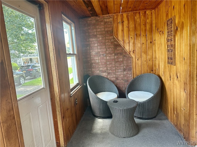 living area with brick wall and wooden walls