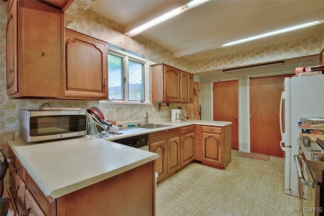 kitchen featuring white appliances, light tile patterned floors, kitchen peninsula, decorative backsplash, and sink