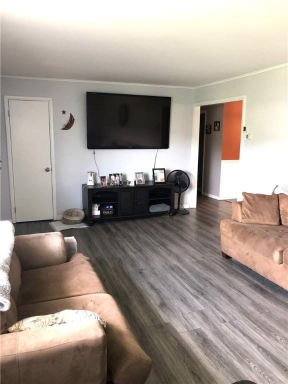 living room featuring ornamental molding and wood finished floors