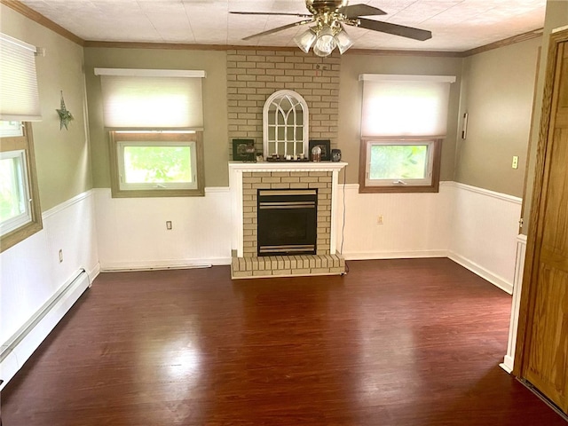 unfurnished living room with dark wood-style floors, a fireplace, a baseboard heating unit, and a wainscoted wall