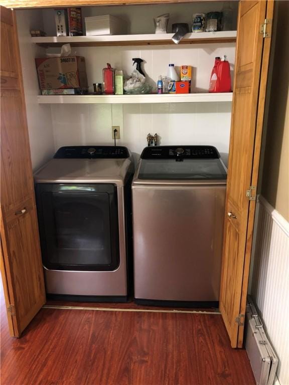 washroom with laundry area, separate washer and dryer, and dark wood finished floors