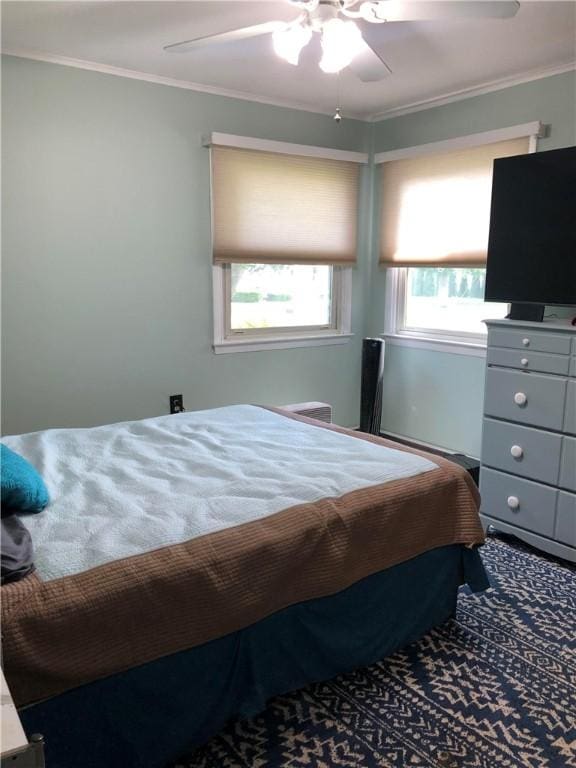 bedroom with ornamental molding and a ceiling fan