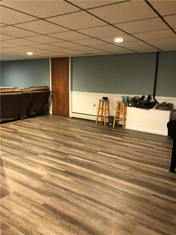 finished basement with a drop ceiling, wood finished floors, and recessed lighting