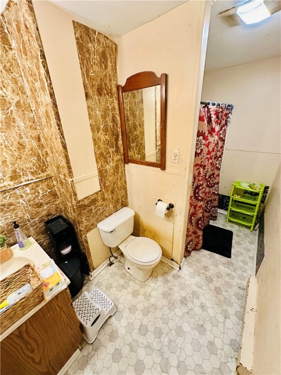 bathroom with vanity, toilet, and tile patterned flooring