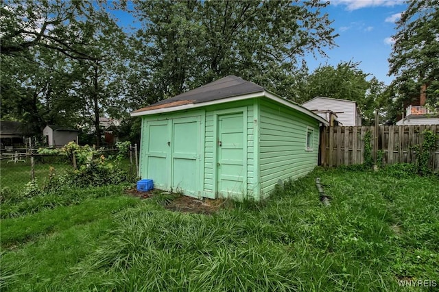 view of shed with fence