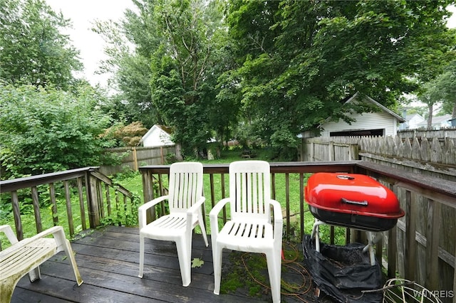 wooden terrace with a grill