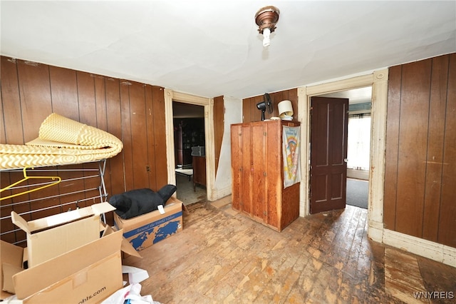 interior space featuring wood walls and hardwood / wood-style flooring