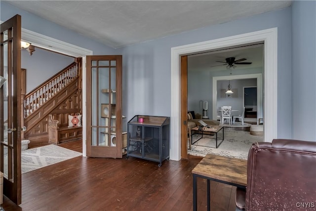 living room with dark hardwood / wood-style floors and ceiling fan