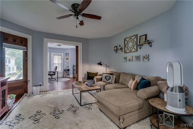 living room with hardwood / wood-style flooring and ceiling fan