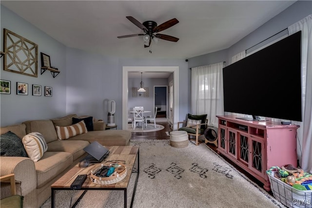 living room featuring hardwood / wood-style flooring and ceiling fan