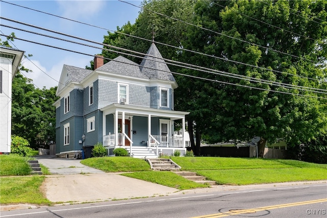 victorian-style house with a front lawn and covered porch