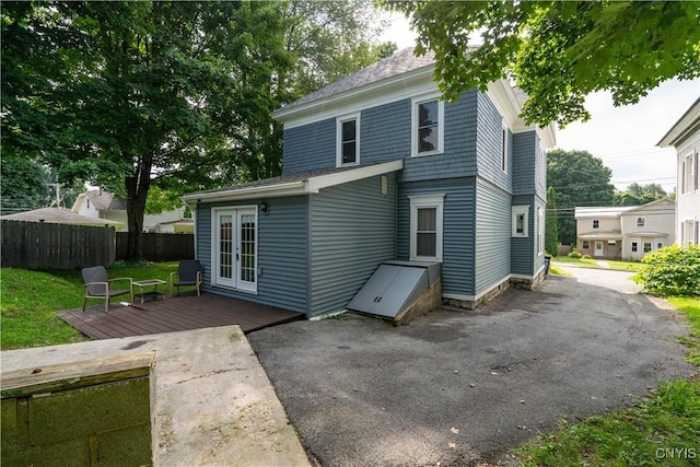 back of house featuring french doors and a deck