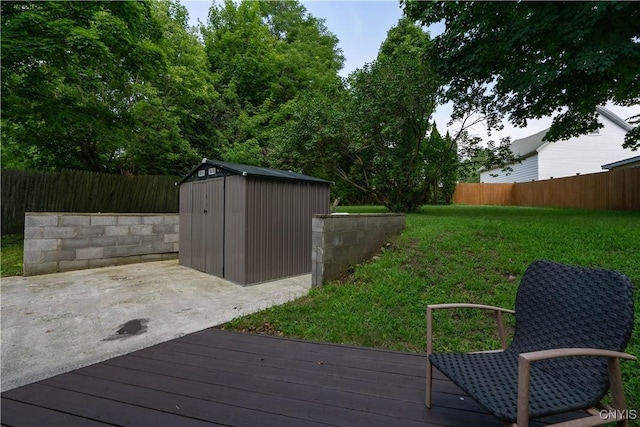 wooden terrace featuring a yard and a shed