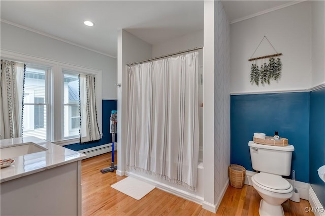 full bathroom with hardwood / wood-style floors, a baseboard radiator, shower / tub combo, toilet, and crown molding