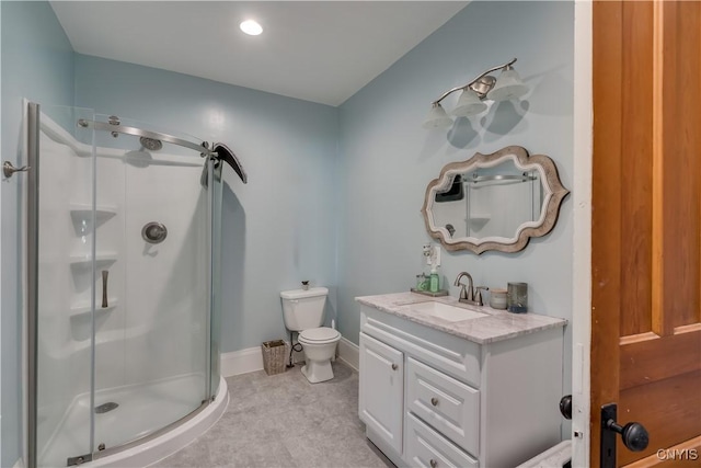 bathroom with a shower with door, vanity, and toilet