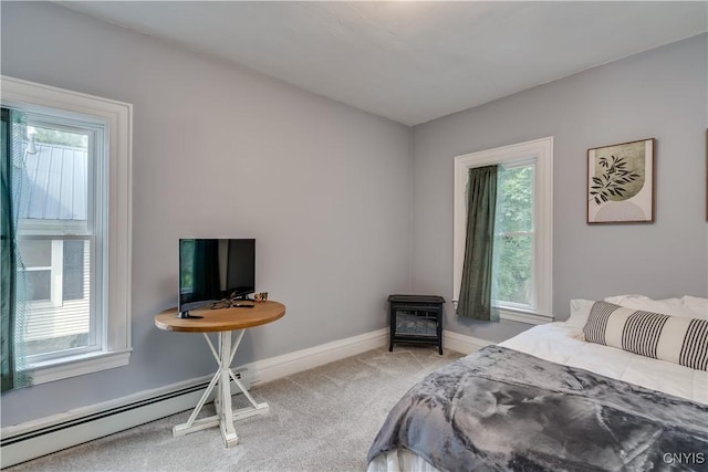 carpeted bedroom featuring a baseboard radiator