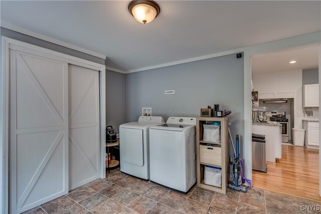 laundry area with a barn door and separate washer and dryer