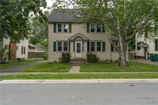 colonial-style house with a front lawn