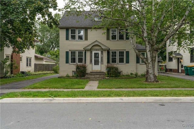 colonial home with a front lawn