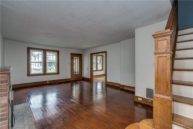 unfurnished living room featuring dark wood-type flooring