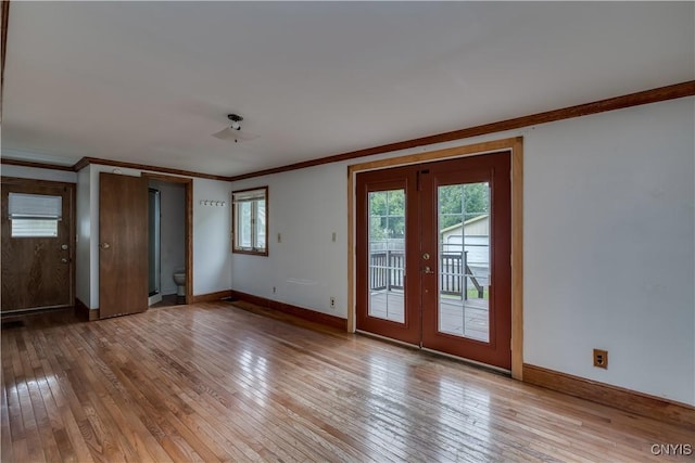 interior space featuring french doors, ornamental molding, access to exterior, and light hardwood / wood-style flooring