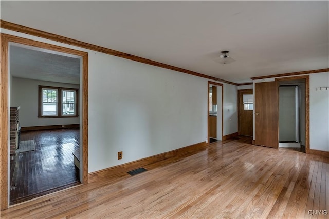 interior space featuring light hardwood / wood-style flooring and ornamental molding