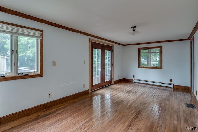 unfurnished room with crown molding, baseboard heating, light hardwood / wood-style floors, a healthy amount of sunlight, and french doors