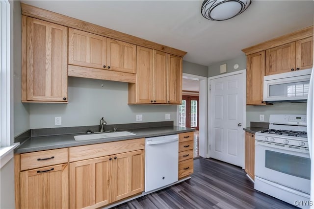 kitchen with light brown cabinets, sink, dark wood-type flooring, and white appliances