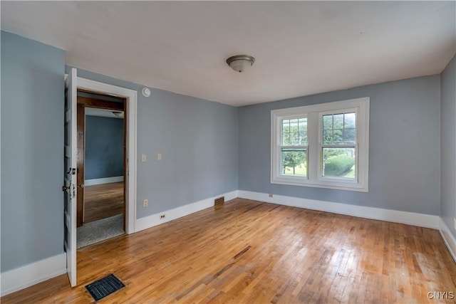 empty room with wood-type flooring