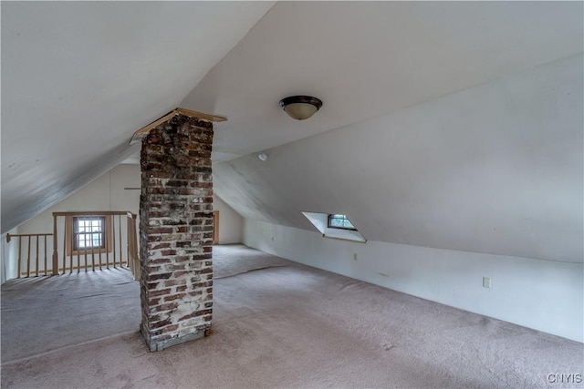 bonus room featuring light carpet and lofted ceiling