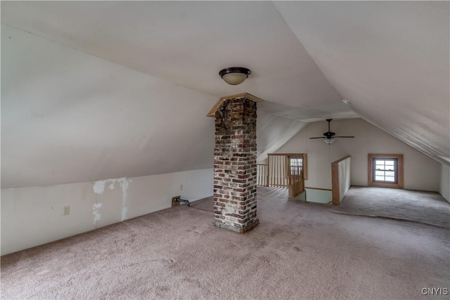 additional living space featuring carpet floors and vaulted ceiling