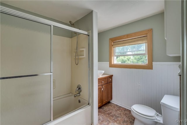 full bathroom featuring enclosed tub / shower combo, vanity, and toilet