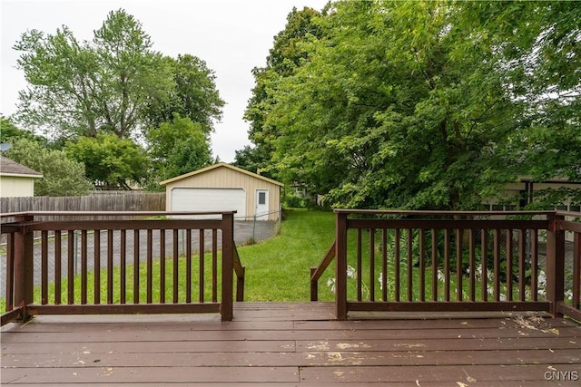 wooden terrace with a garage, an outdoor structure, and a yard