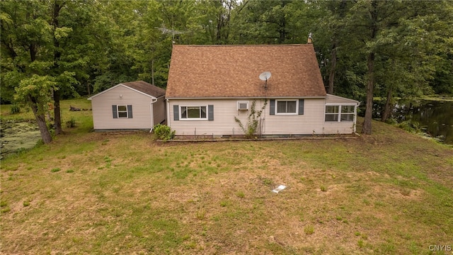 rear view of house featuring a yard