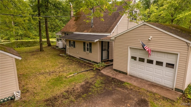 view of front of house with a garage and a front lawn