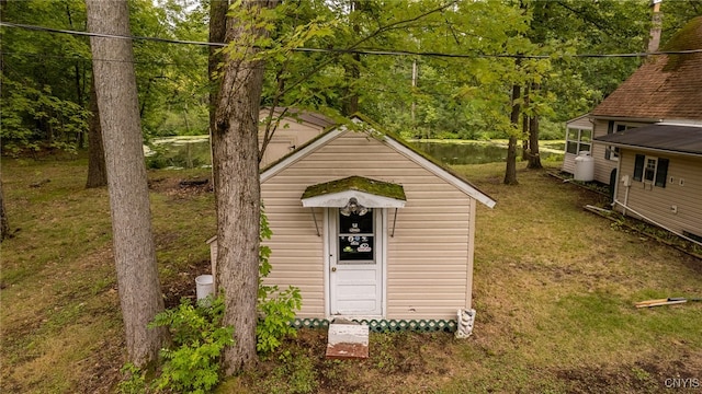 view of outbuilding featuring a lawn