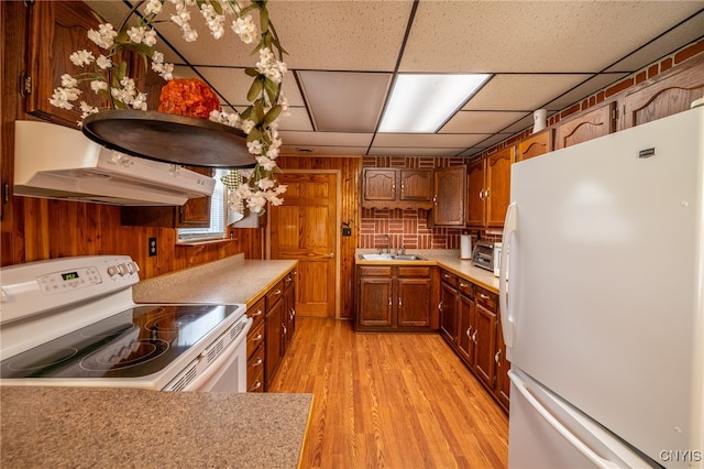 kitchen with custom range hood, light hardwood / wood-style flooring, white appliances, a paneled ceiling, and sink