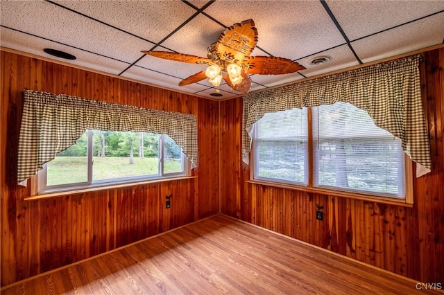 unfurnished sunroom with a drop ceiling and ceiling fan