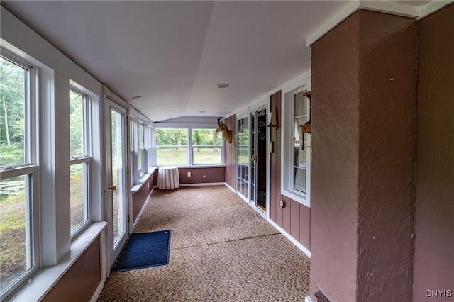 unfurnished sunroom with vaulted ceiling