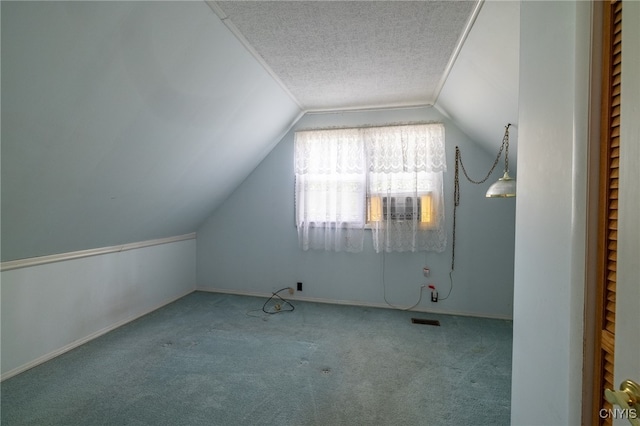 bonus room with carpet flooring, vaulted ceiling, and a textured ceiling