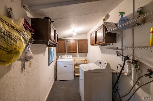 clothes washing area featuring cabinets, washer and clothes dryer, and a textured ceiling