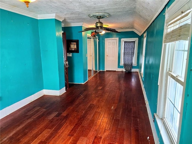 hall with hardwood / wood-style flooring, crown molding, a wealth of natural light, and a textured ceiling