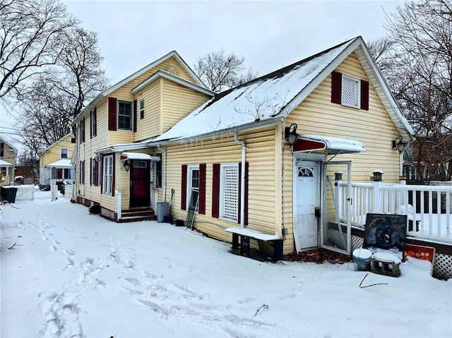 view of snow covered rear of property