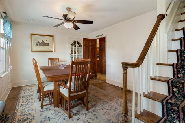 dining area with ceiling fan and wood-type flooring